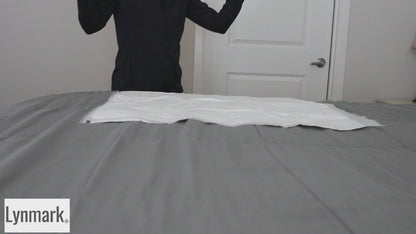 Video showing Lynmark white washable bed protector pad with tucks in use